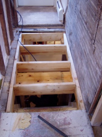 Framing the floor where the staircase was removed on second floor.